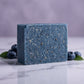 You will be generating high-quality product photos for an online stores product page. The product images should closely match the original products.
      Here is the prompt (IMPORTANT!): """A close-up studio shot of the Blueberry Scrub Soap, placed on a r