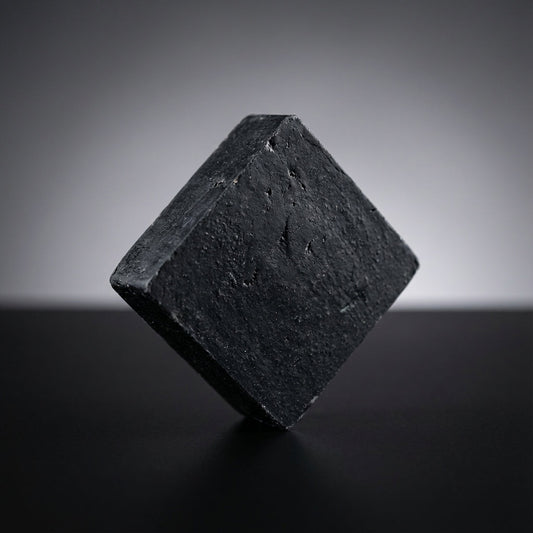 You will be generating high-quality product photos for an online stores product page. The product images should closely match the original products.
      Here is the prompt (IMPORTANT!): """A high-resolution studio shot of the Charcoal Soap prominently po