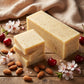 You will be generating high-quality product photos for an online stores product page. The product images should closely match the original products.
      Here is the prompt (IMPORTANT!): """A high-angle, overhead shot of the Cherry Almond Soap set on a ru