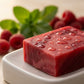 You will be generating high-quality product photos for an online stores product page. The product images should closely match the original products.
      Here is the prompt (IMPORTANT!): """A macro shot of the Raspberry Mint Soap in a premium studio setti