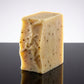 You will be generating high-quality product photos for an online stores product page. The product images should closely match the original products.
      Here is the prompt (IMPORTANT!): """A studio shot of the Tangerine Grapefruit Soap standing upright o