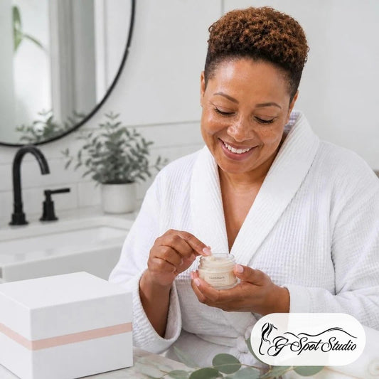 Luminary Glow-Getter Radiance Ritual Box: a smiling woman applying body butter beside her white ritual box